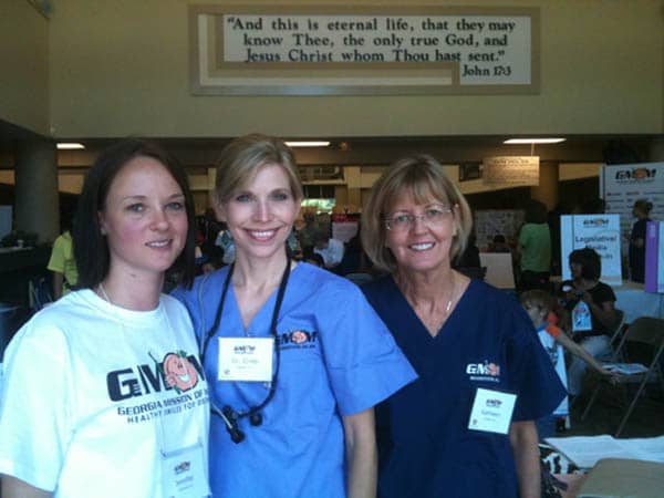 Photo of three Cheek Dental team members, including Dr. Cristi Cheek, volunteering at the Georgia Mission of Mercy.