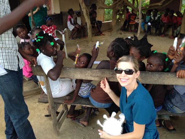 Photo of Dr. Cristi Cheek of East Cobb with children in a village in Haiti for whom she provided dental care through the 410 Bridge, a Christian mission organization.