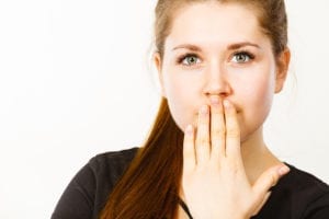 woman covering her mouth with her hand