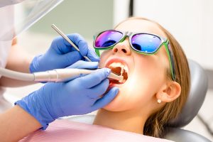 Child in a dental chair being treated. 