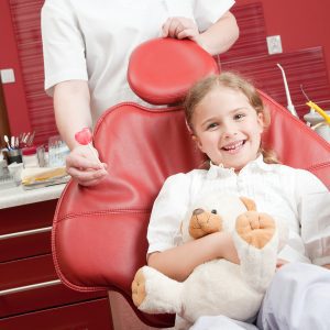 A young girl in a pediatirc dental chair